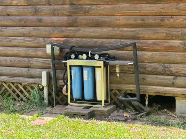 a view of a house with swimming pool and next to a big yard