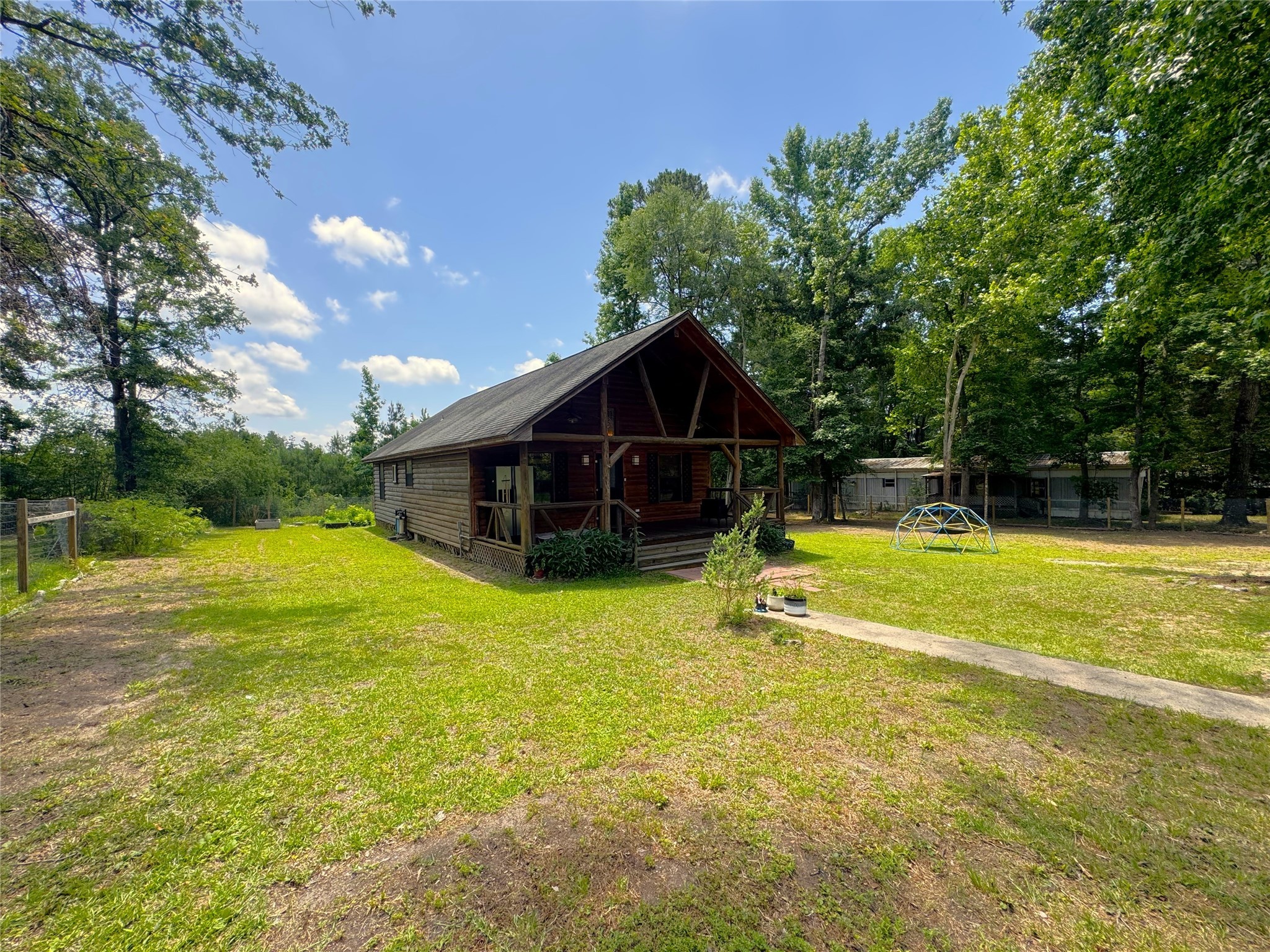 798 Port Boulevard Trinity, TX 75862 - Photo 30 of 31 a view of a house with pool and a yard