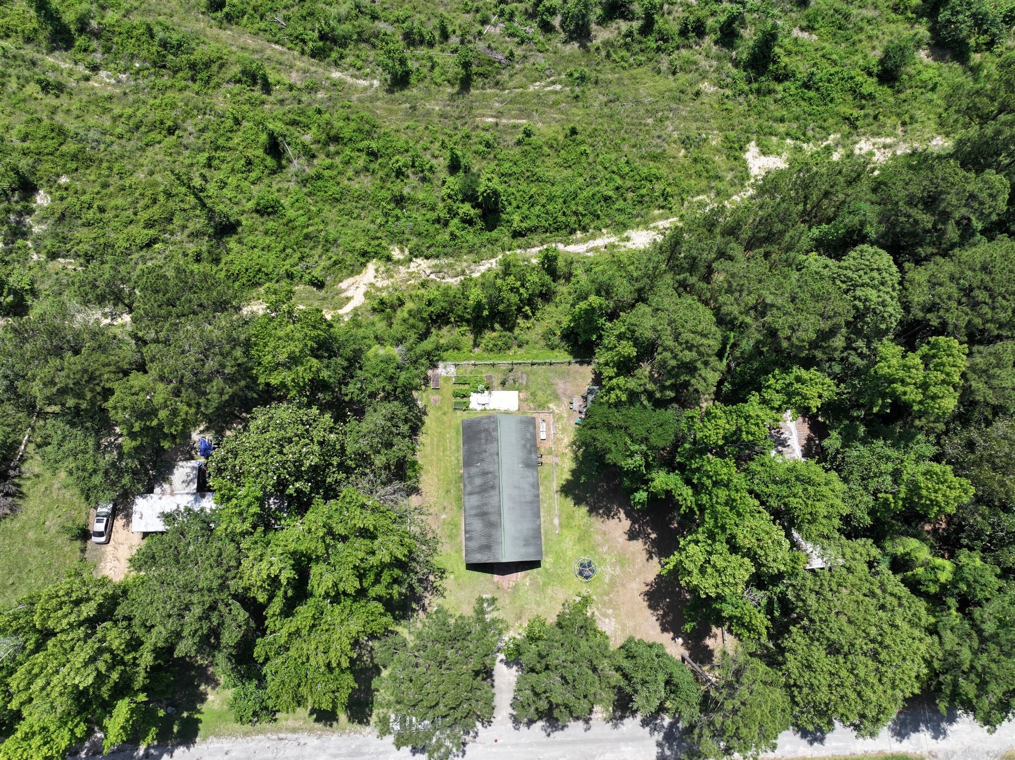 798 Port Boulevard Trinity, TX 75862 - Photo 31 of 31 an aerial view of a house with a yard and large trees