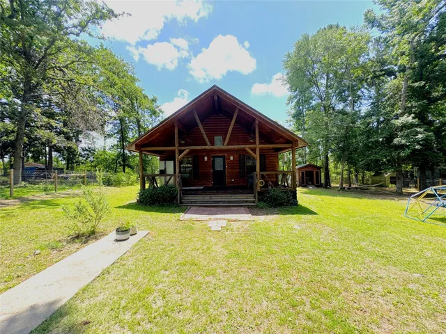 a view of a house with pool and a yard