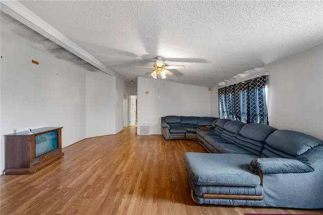 a living room with furniture and a ceiling fan
