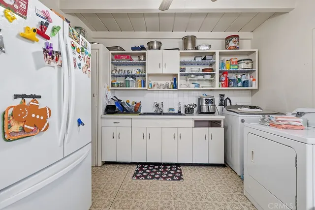 a kitchen with stainless steel appliances a white refrigerator and a sink