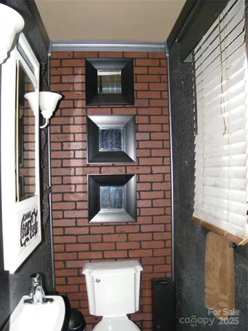 a kitchen with stainless steel appliances a sink cabinets and wooden floor