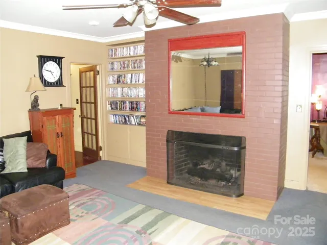 a bed sitting in a bedroom next to a window with wooden floor