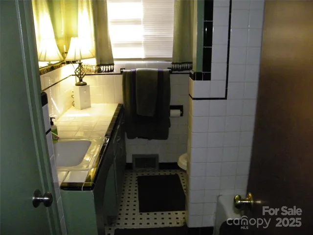 a bedroom with a bed table closet and a window