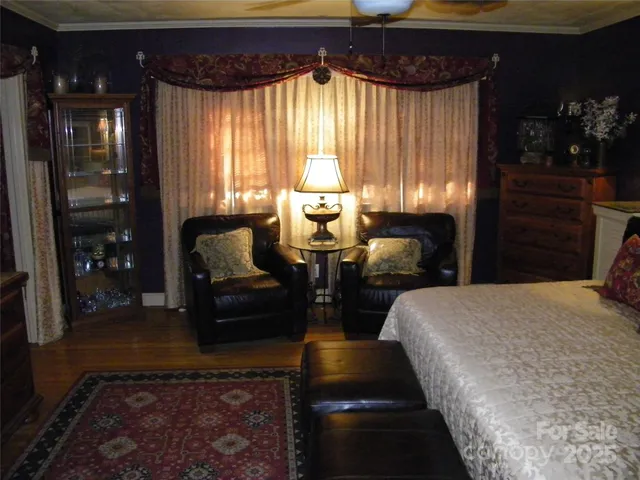 a view of a workspace room with furniture and a chandelier