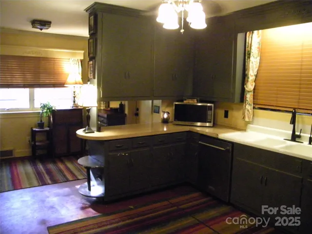 a kitchen with a sink appliances and a window