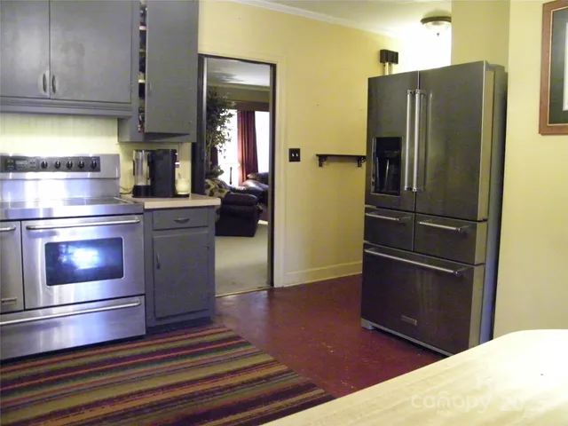 a kitchen with granite countertop stainless steel appliances and wooden cabinets