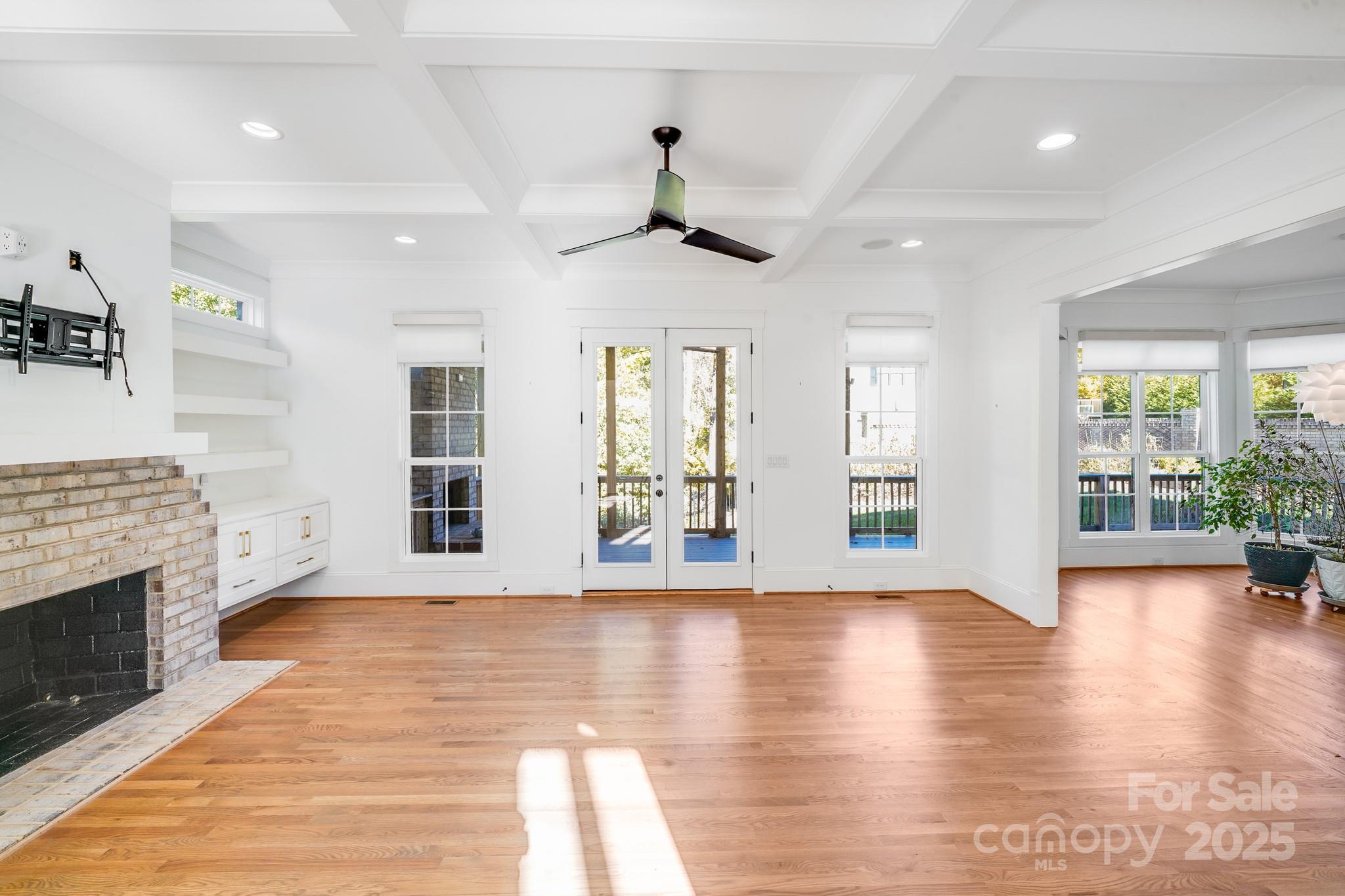 6541 Gardner Lane Charlotte, NC 28270 - Photo 13 of 47 a view of an empty room with wooden floor and a fireplace