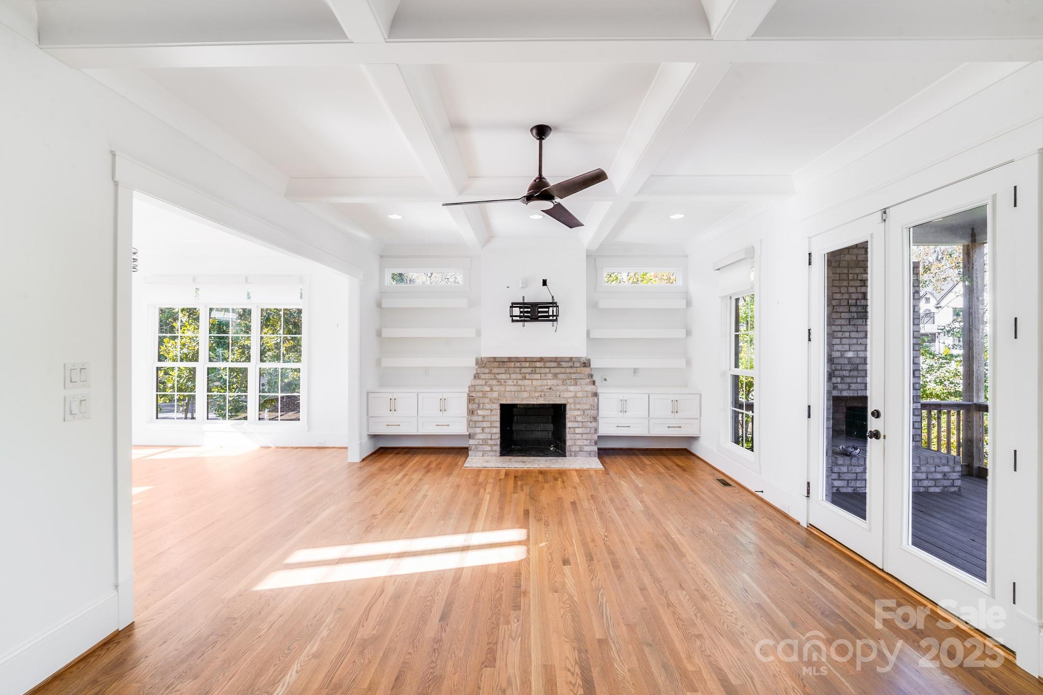 6541 Gardner Lane Charlotte, NC 28270 - Photo 14 of 47 wooden floor fireplace and windows in an empty room