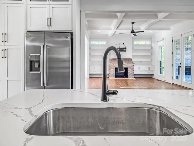 a kitchen with a sink and a refrigerator