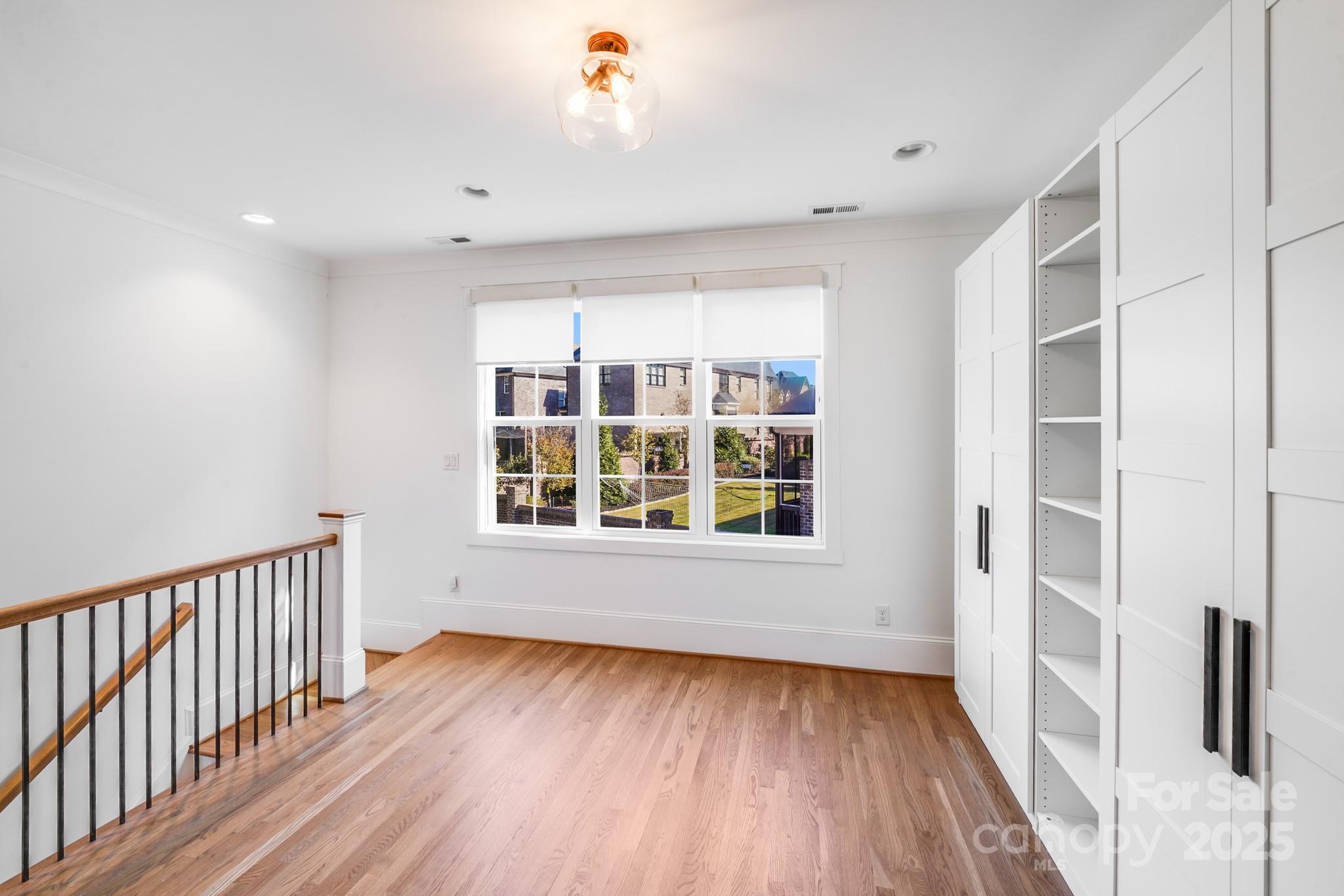 6541 Gardner Lane Charlotte, NC 28270 - Photo 26 of 47 a view of an empty room with wooden floor and a window