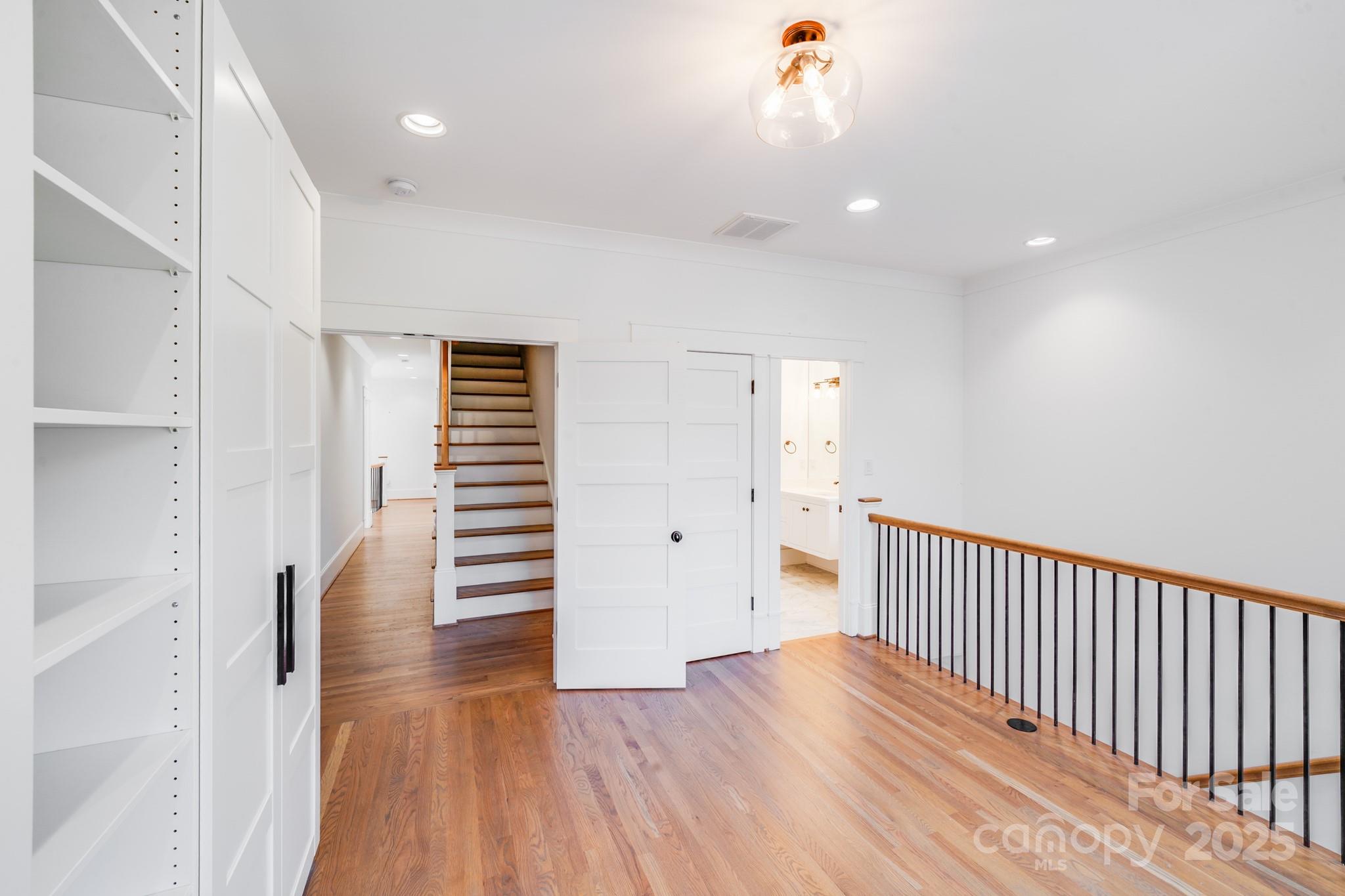6541 Gardner Lane Charlotte, NC 28270 - Photo 28 of 47 a view of a hallway with wooden floor and stairs
