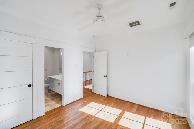 a view of hallway with wooden floor