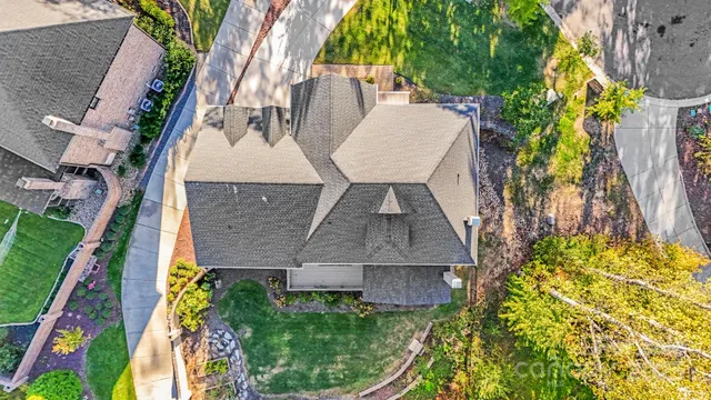 an aerial view of a house with garden space and swimming pool
