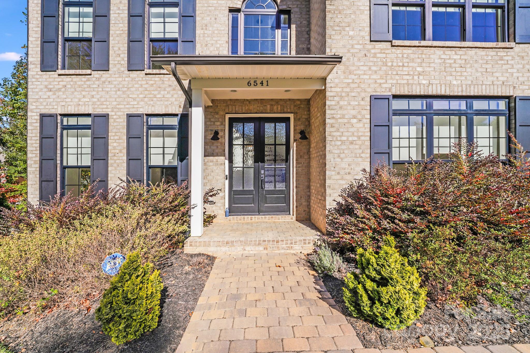 6541 Gardner Lane Charlotte, NC 28270 - Photo 5 of 47 front view of a brick house with a large door