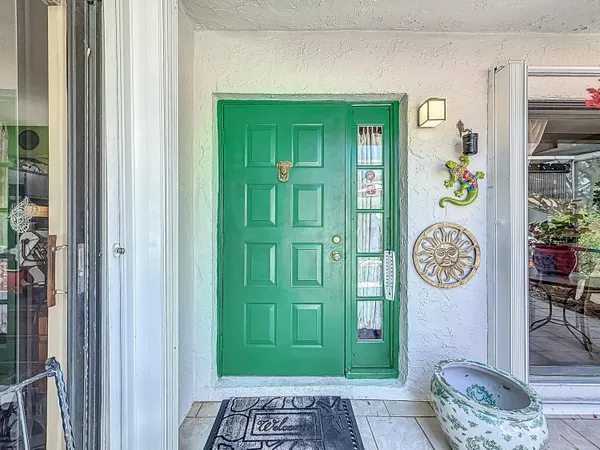 a spacious bedroom with a bed and a chandelier