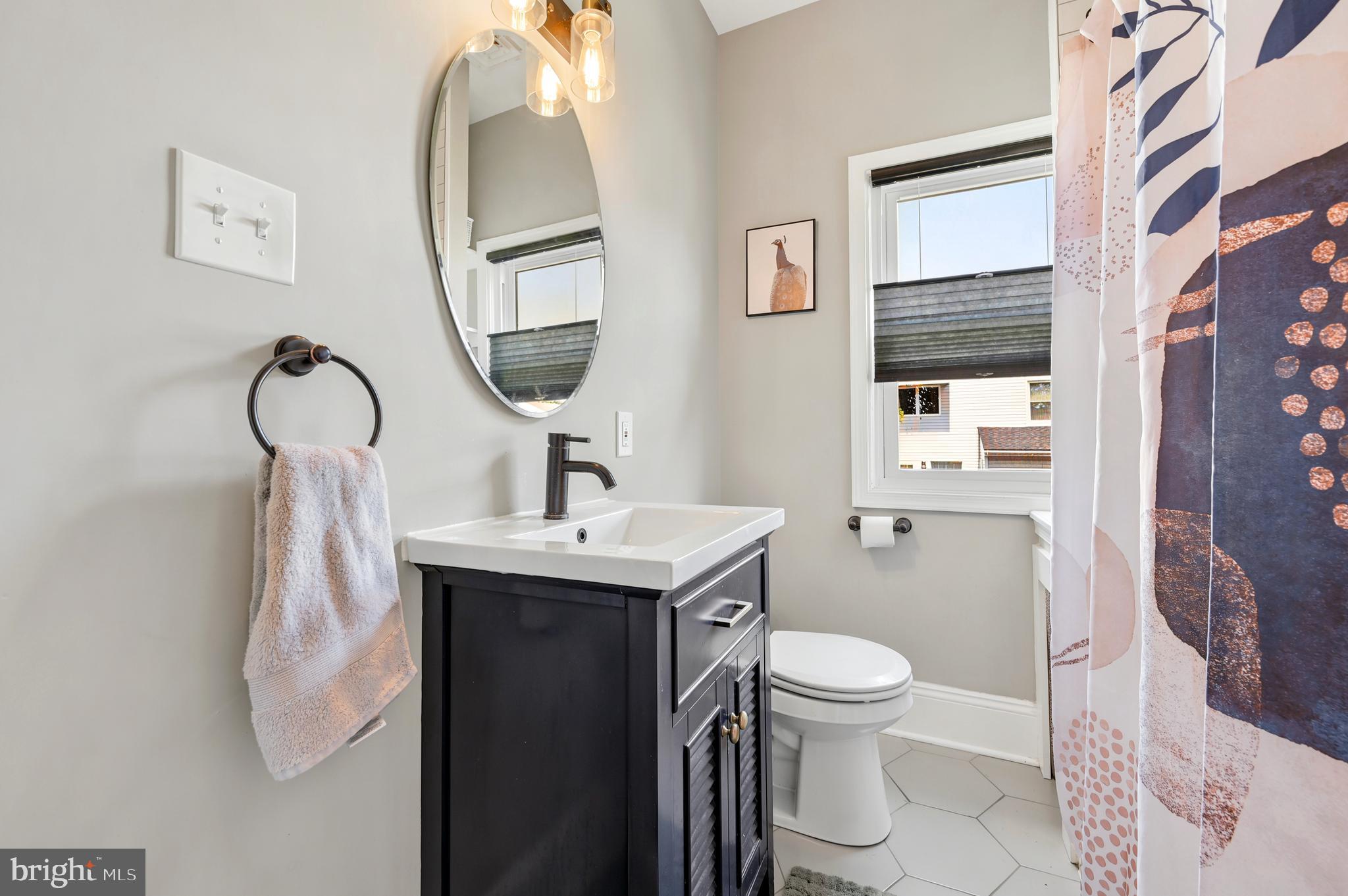 211 North Sylvania Avenue Jenkintown, PA 19046 - Photo 11 of 17 a bathroom with a toilet sink and mirror