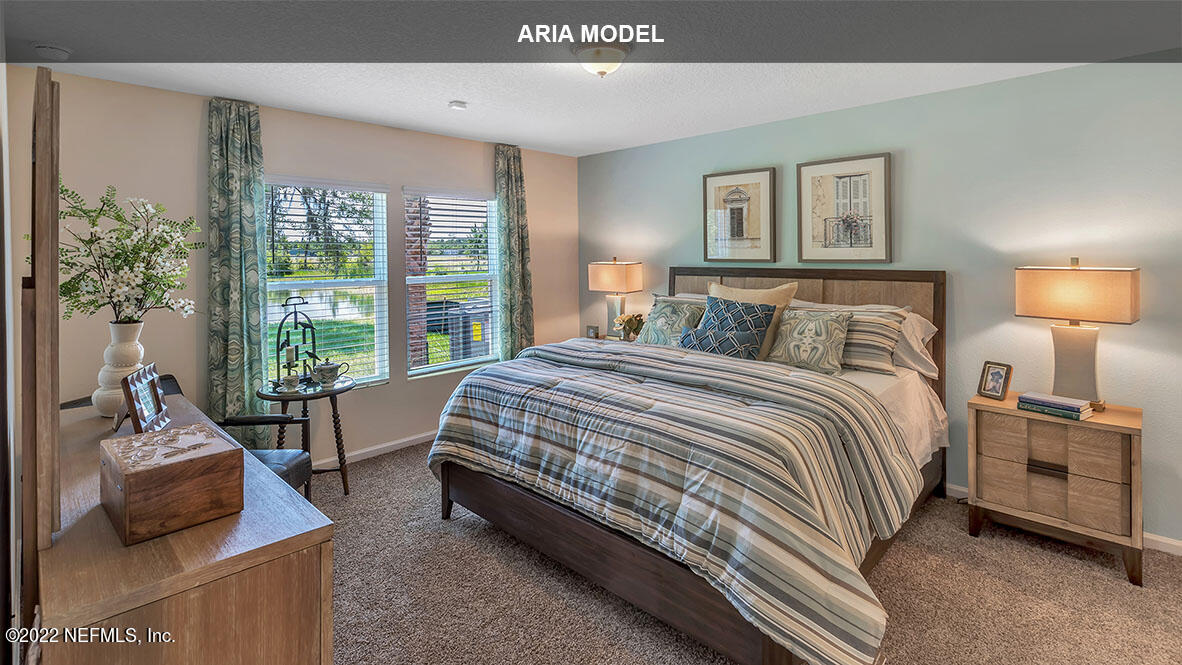 65458 River Glen Parkway Yulee, FL 32097 - Photo 13 of 47 a bedroom with a bed and a couch