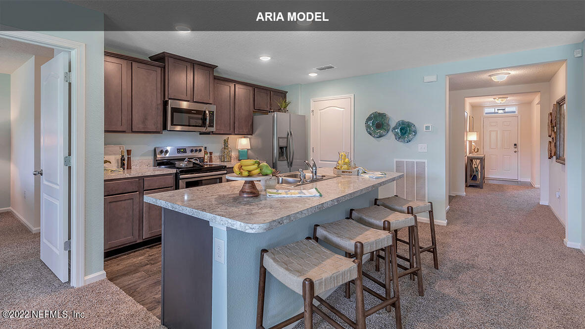 65458 River Glen Parkway Yulee, FL 32097 - Photo 6 of 47 a kitchen with a sink cabinets and wooden floor