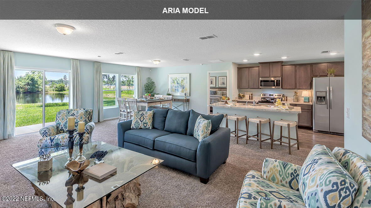 65458 River Glen Parkway Yulee, FL 32097 - Photo 9 of 47 a living room with furniture and a large window