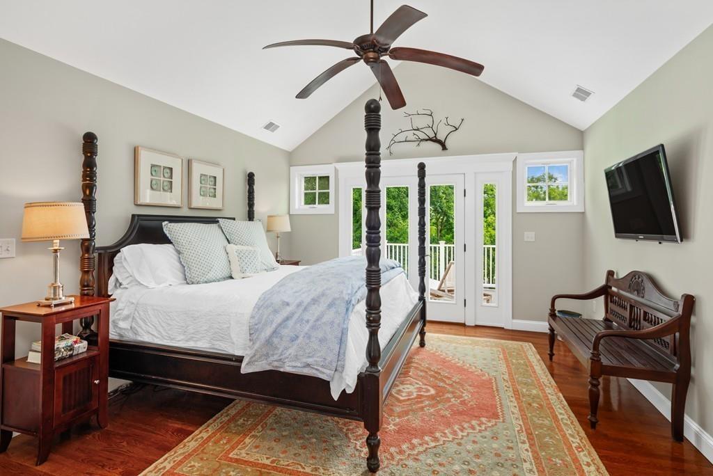 41 Kimball Beach Road Hingham, MA 02043 - Photo 19 of 42 a spacious bedroom with a bed a couch and a flat tv screen on the dresser