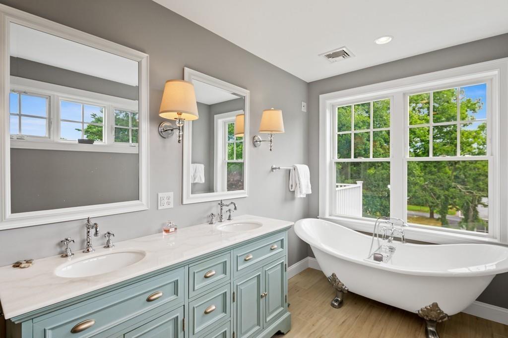 41 Kimball Beach Road Hingham, MA 02043 - Photo 22 of 42 a bathroom with a double vanity sink tub and mirror
