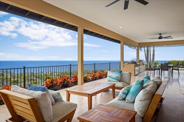a living room with furniture a floor to ceiling window and a flat screen tv