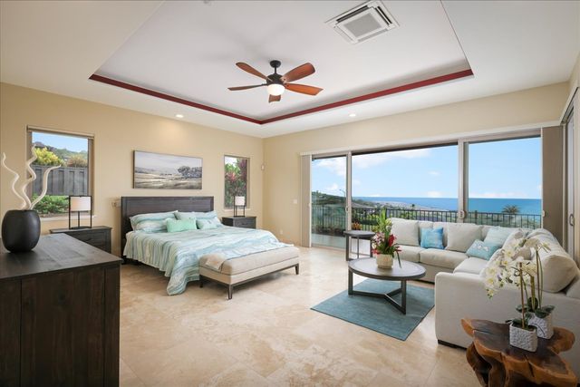 a bedroom with a bed couch and large window