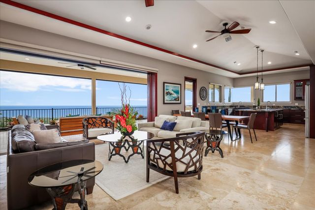 a living room with lots of furniture and a large window