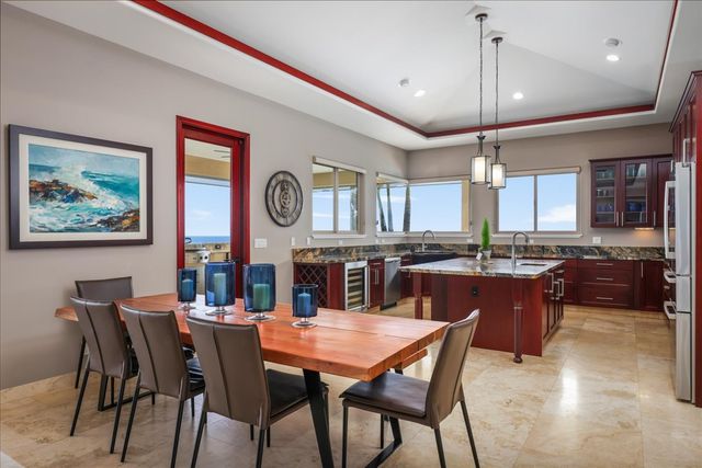 a large kitchen with a table and chairs