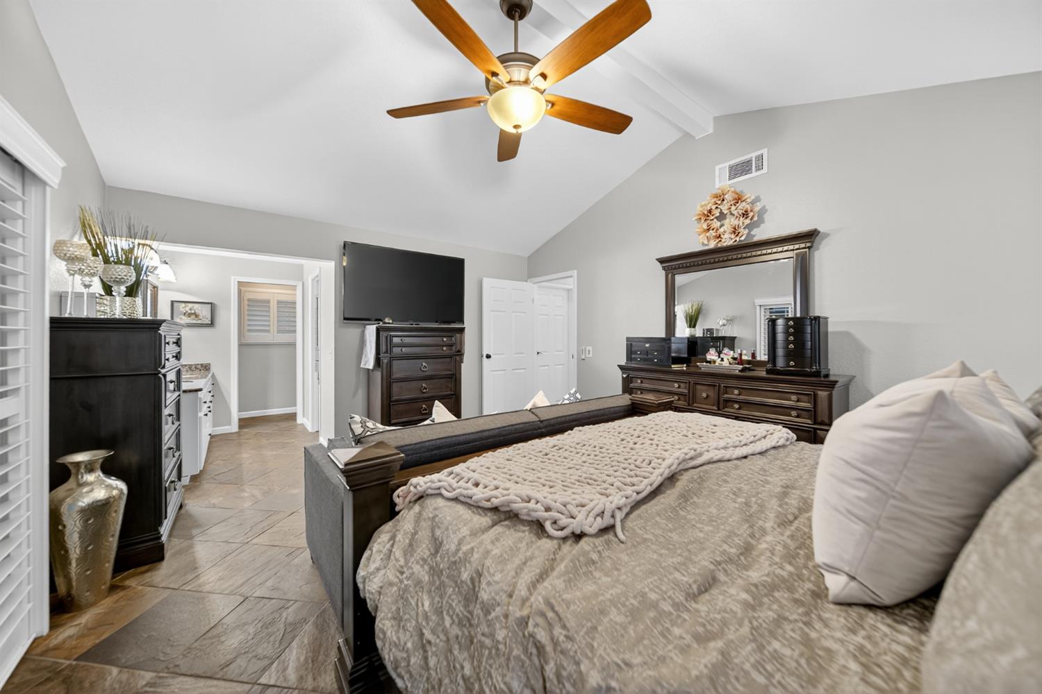 101 Mainberry Drive Madera, CA 93637 - Photo 29 of 40 a bedroom with a bed dresser and a fireplace