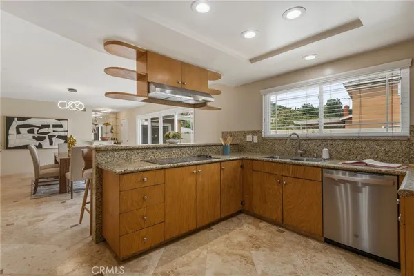 a kitchen with stainless steel appliances granite countertop a sink and stove