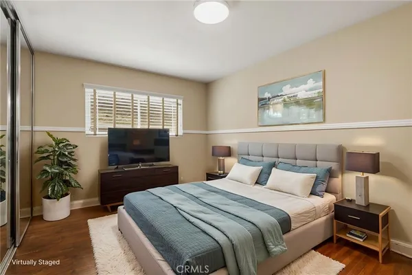 a bedroom with a bed and a flat screen television