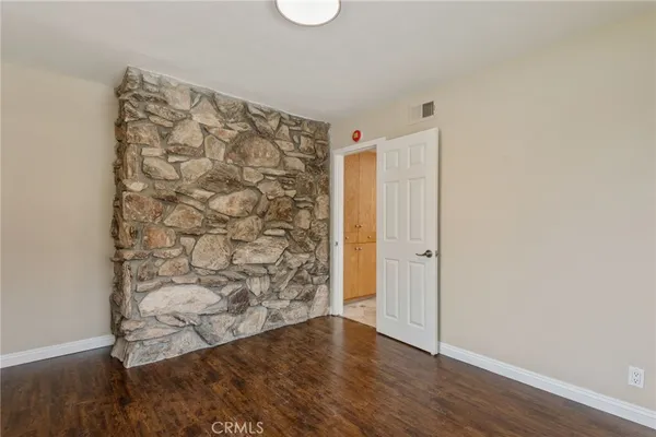 a view of a room with wooden floor and a shower