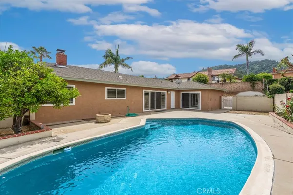 an outdoor space with pool and furniture