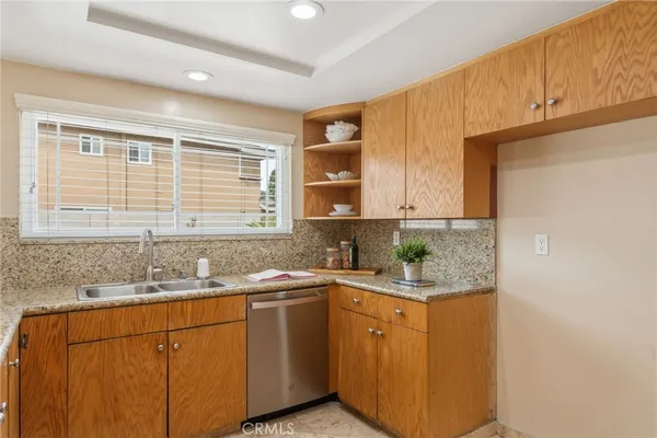 a kitchen with stainless steel appliances granite countertop a sink stove and cabinets