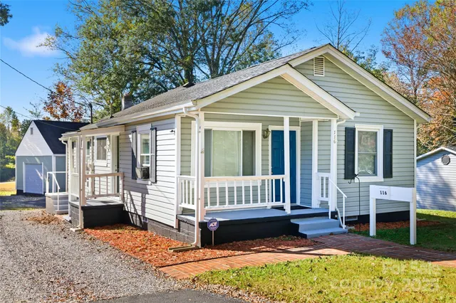 a view of a house with a yard and deck