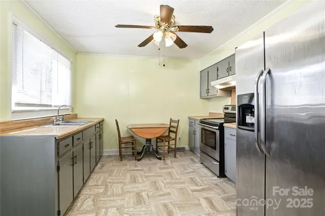 a kitchen with granite countertop a stove and a sink