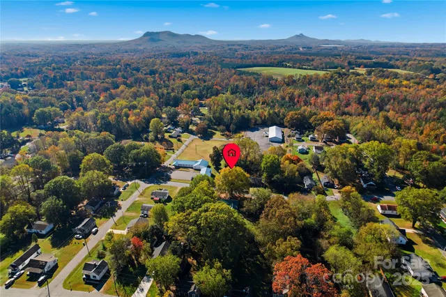 a view of a house with a large window and wooden fence