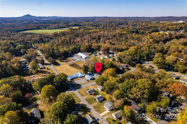 a view of a patio with chairs and a barbeque