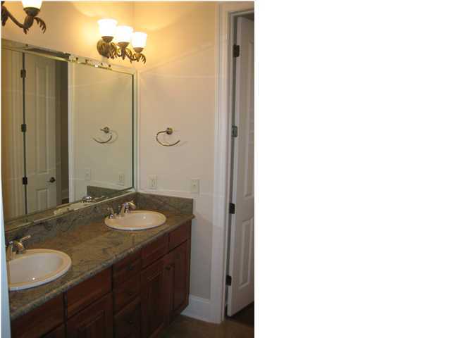 4466 Stonebridge Road Destin, FL 32541 - Photo 15 of 21 a bathroom with a granite countertop sink and a mirror