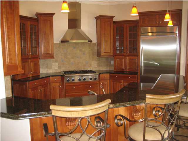 4466 Stonebridge Road Destin, FL 32541 - Photo 3 of 21 a kitchen with stainless steel appliances granite countertop a sink and a stove