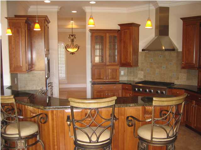 4466 Stonebridge Road Destin, FL 32541 - Photo 4 of 21 a kitchen with a table chairs and a sink