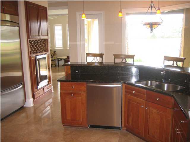 4466 Stonebridge Road Destin, FL 32541 - Photo 5 of 21 a kitchen with stainless steel appliances granite countertop a refrigerator a stove and a sink
