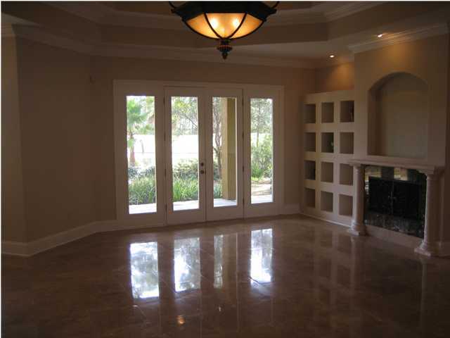 4466 Stonebridge Road Destin, FL 32541 - Photo 7 of 21 a view of an empty room with wooden floor and a window