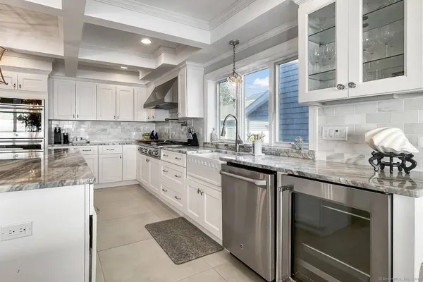 a kitchen with stainless steel appliances granite countertop a sink and cabinets