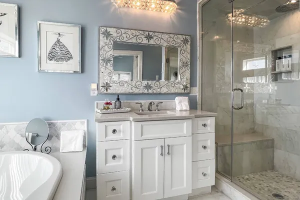 a bathroom with a granite countertop sink mirror and shower