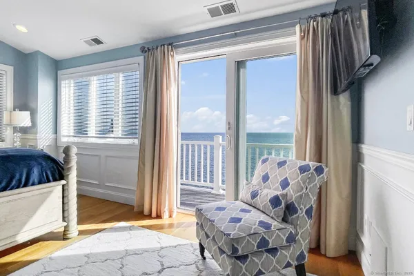 a view of a bedroom with a bed and glass door