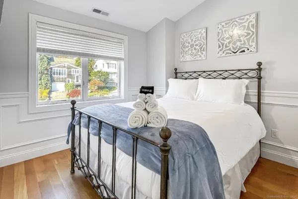 a bed sitting in a bedroom next to a window